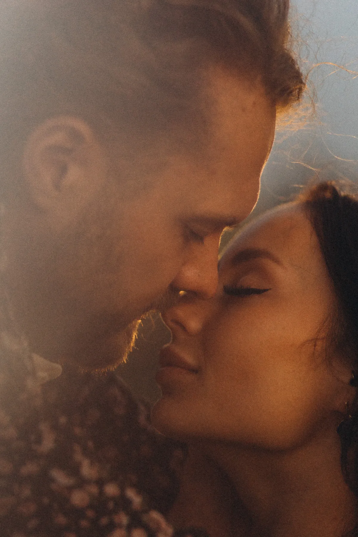 Couple in warm light, their faces very close