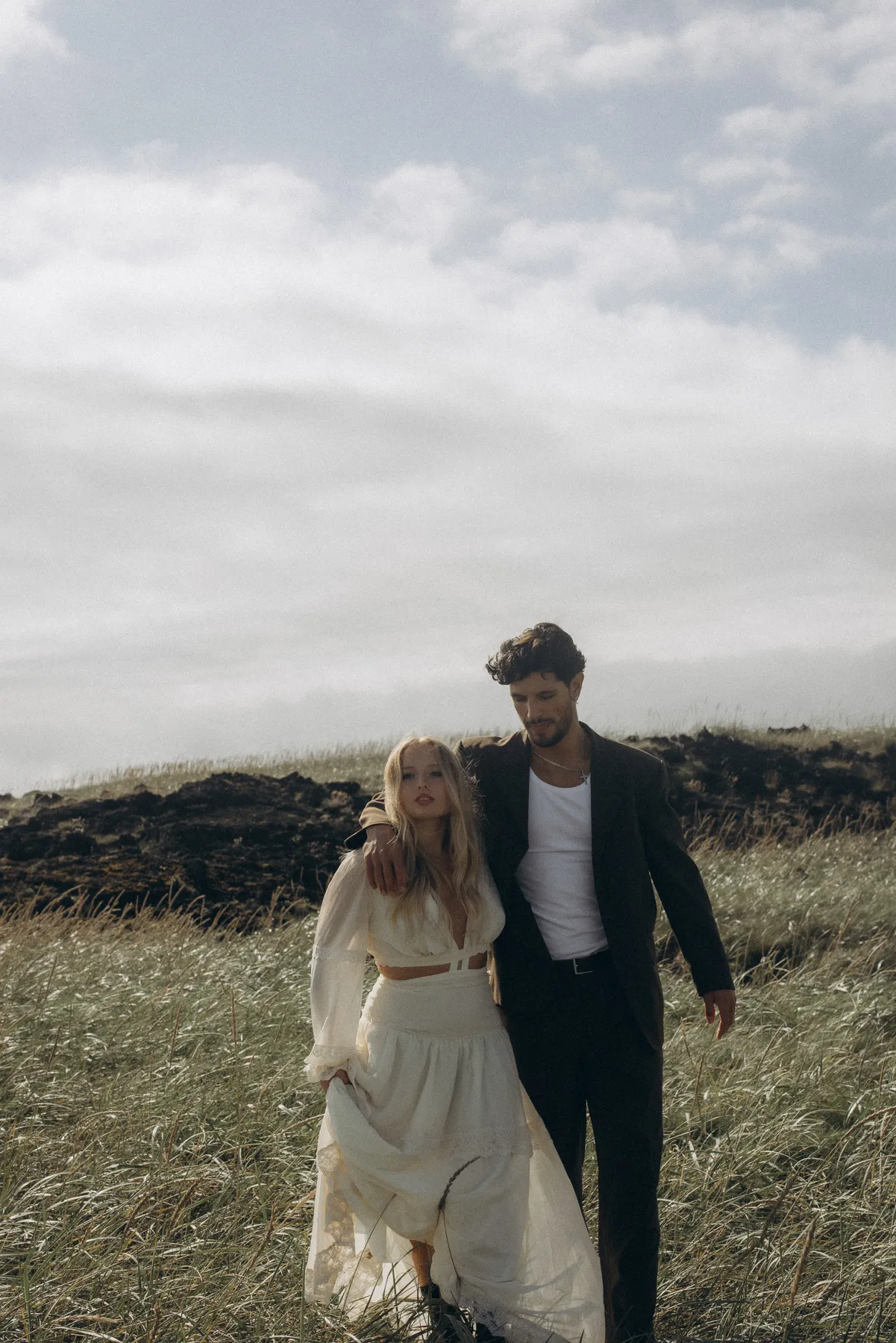 Couple walking across a meadow in Iceland