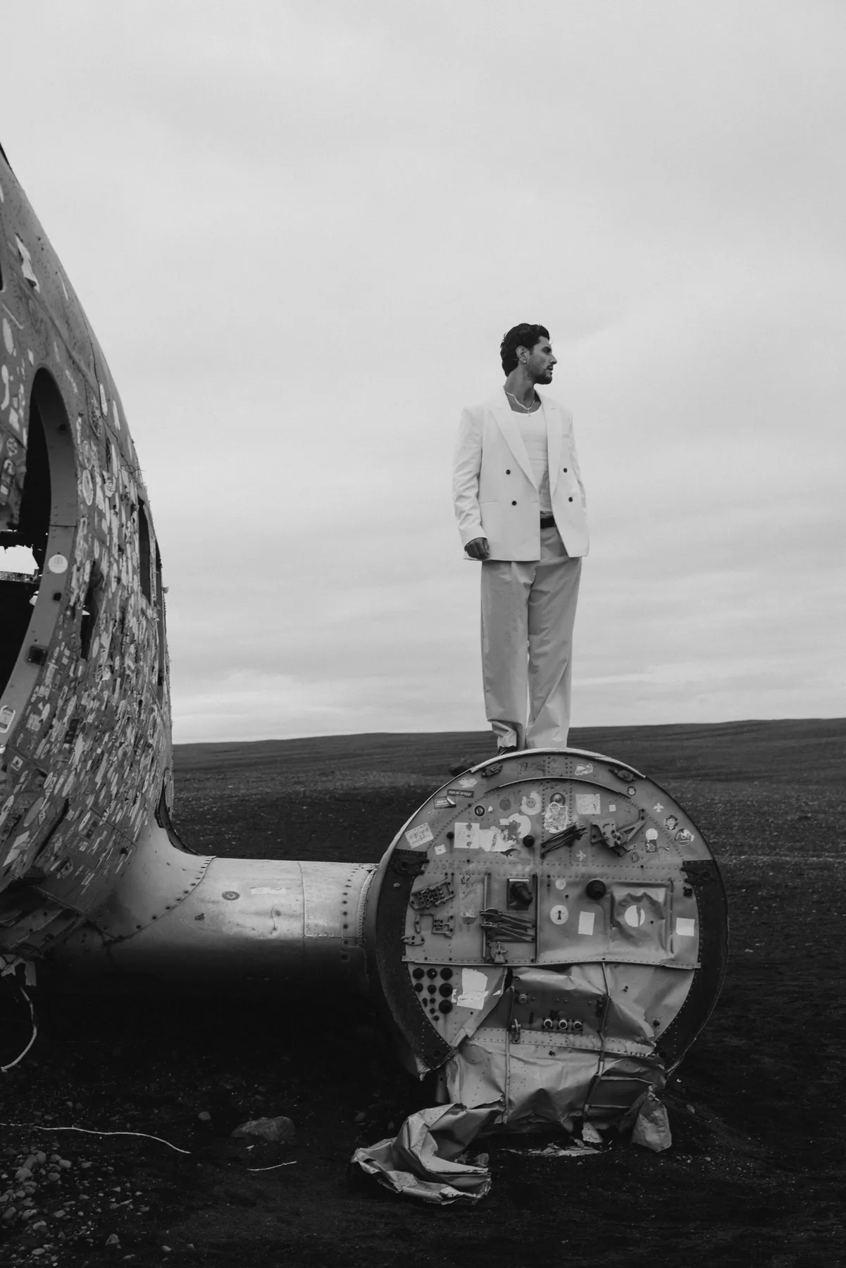 Man standing on a plane wreck in Iceland, black and white