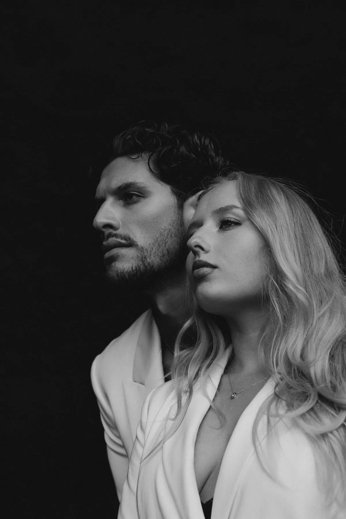 Couple in light suits, portrait in black and white