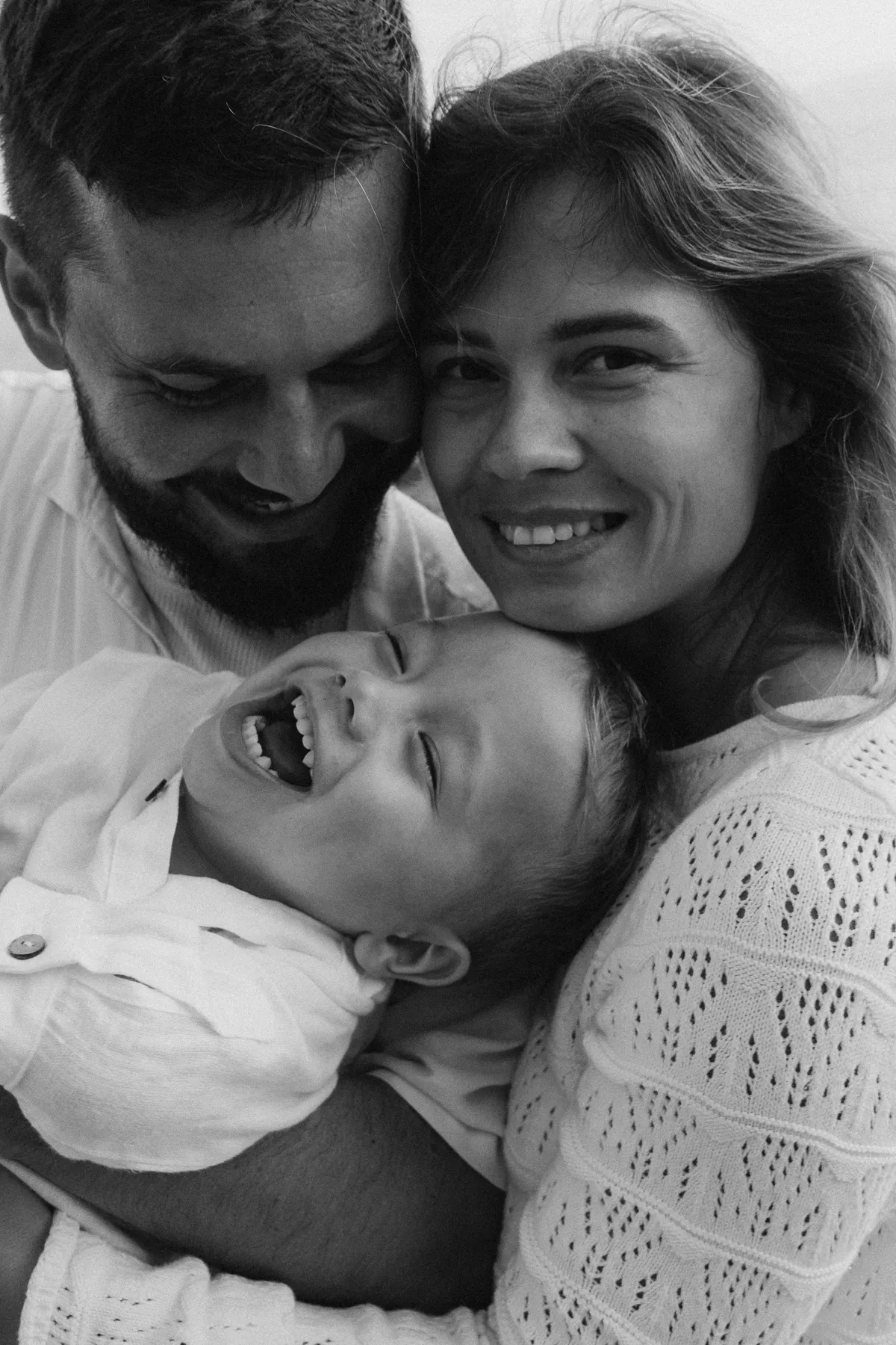 Familie mit Kleinkind lacht – Familienfotos in Spanien, Schwarzweiß