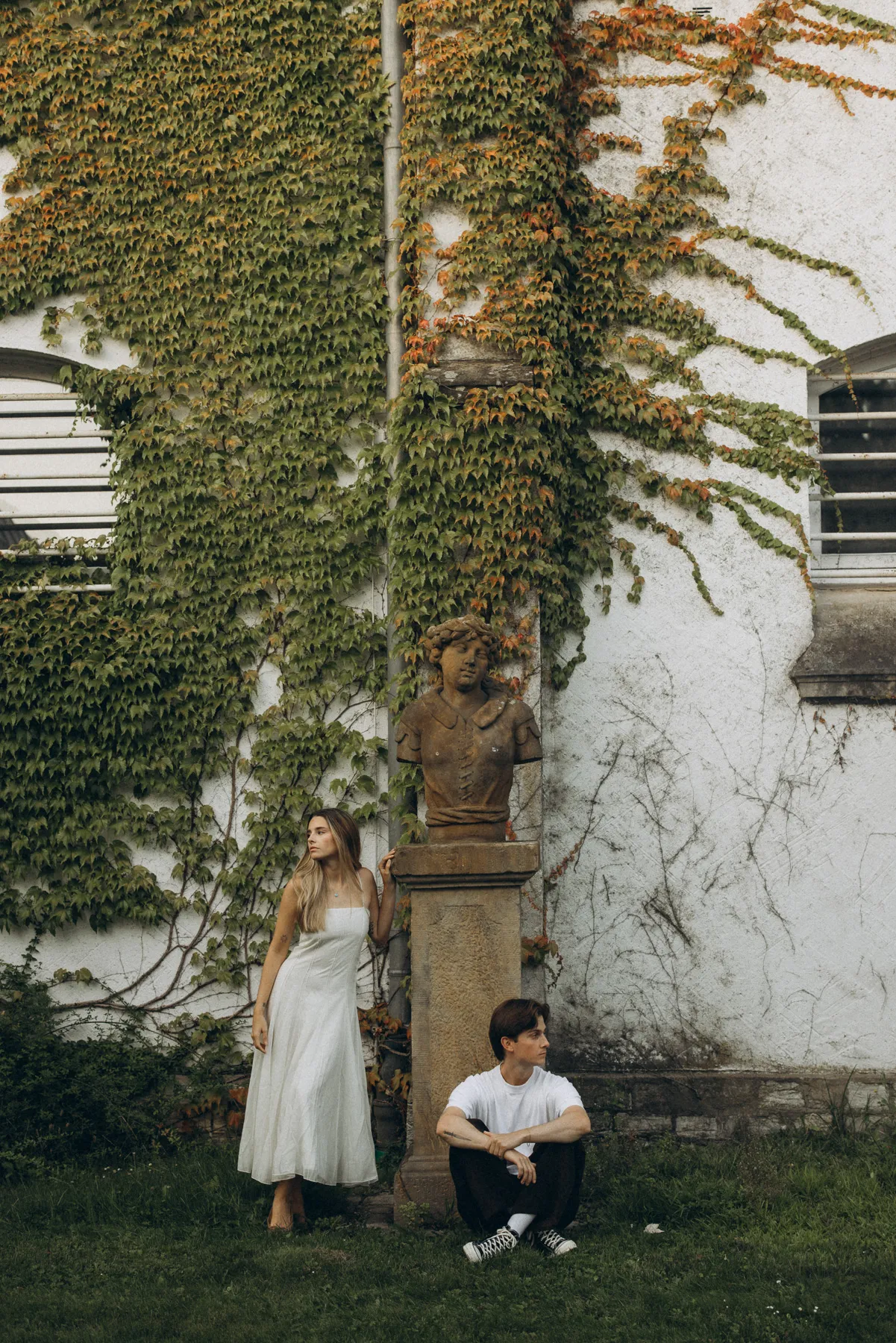 Couple in front of an ivy-covered wall